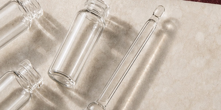 Clear laboratory vials and pipette